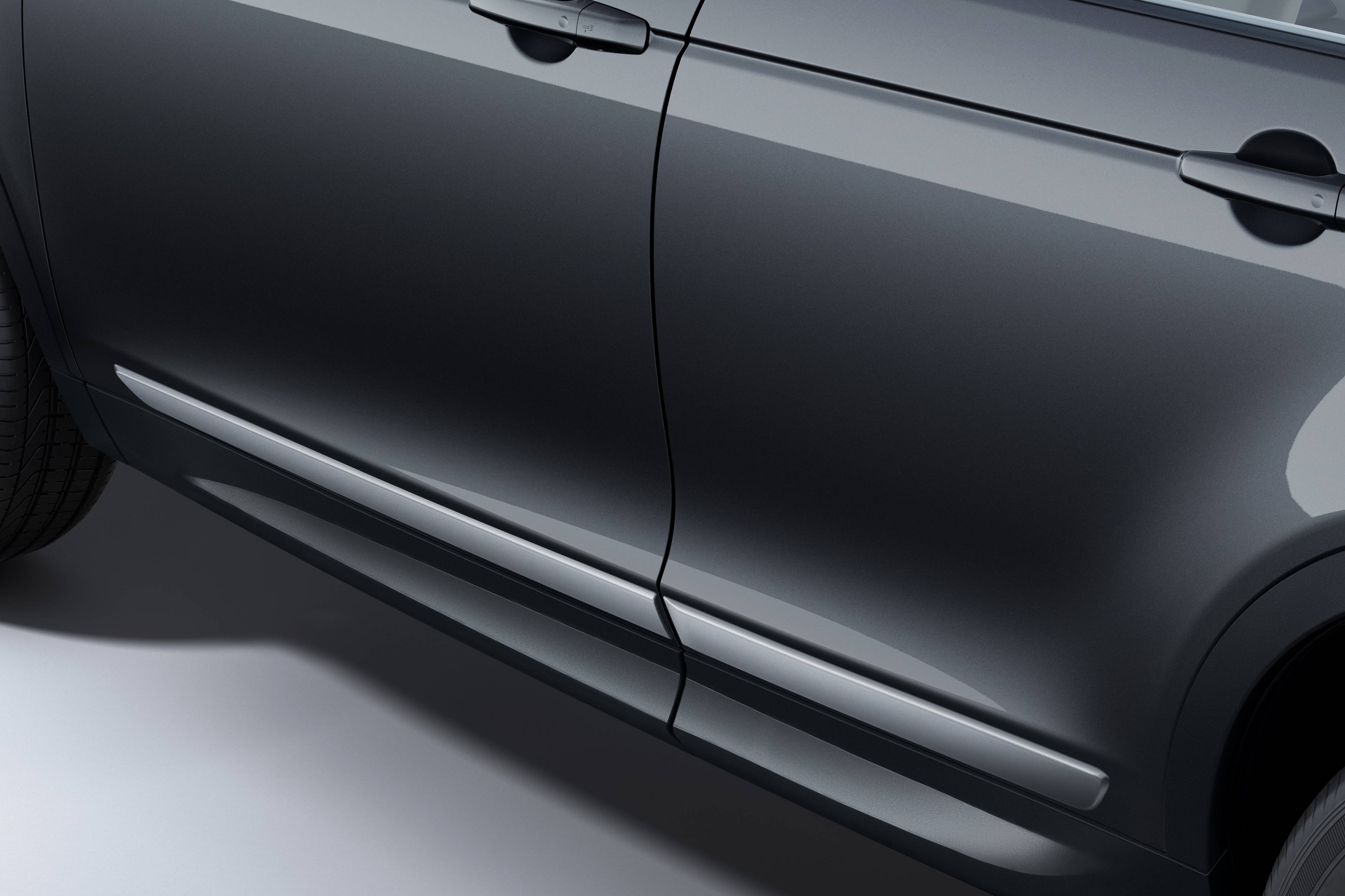 close up of the side of a black discovery sport with side mouldings