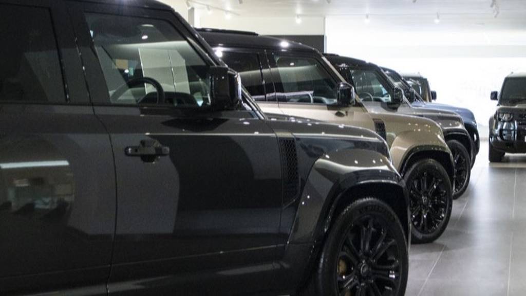 A line-up of Defender models at Sytner Land Rover South West London.