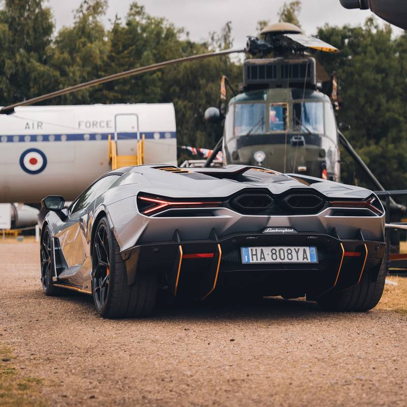 Back of a Lamborghini Revuelto in sliver with orange trims
