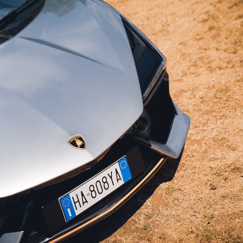 Front quarter close up of Lamborghini Revuelto in sliver with orange trims