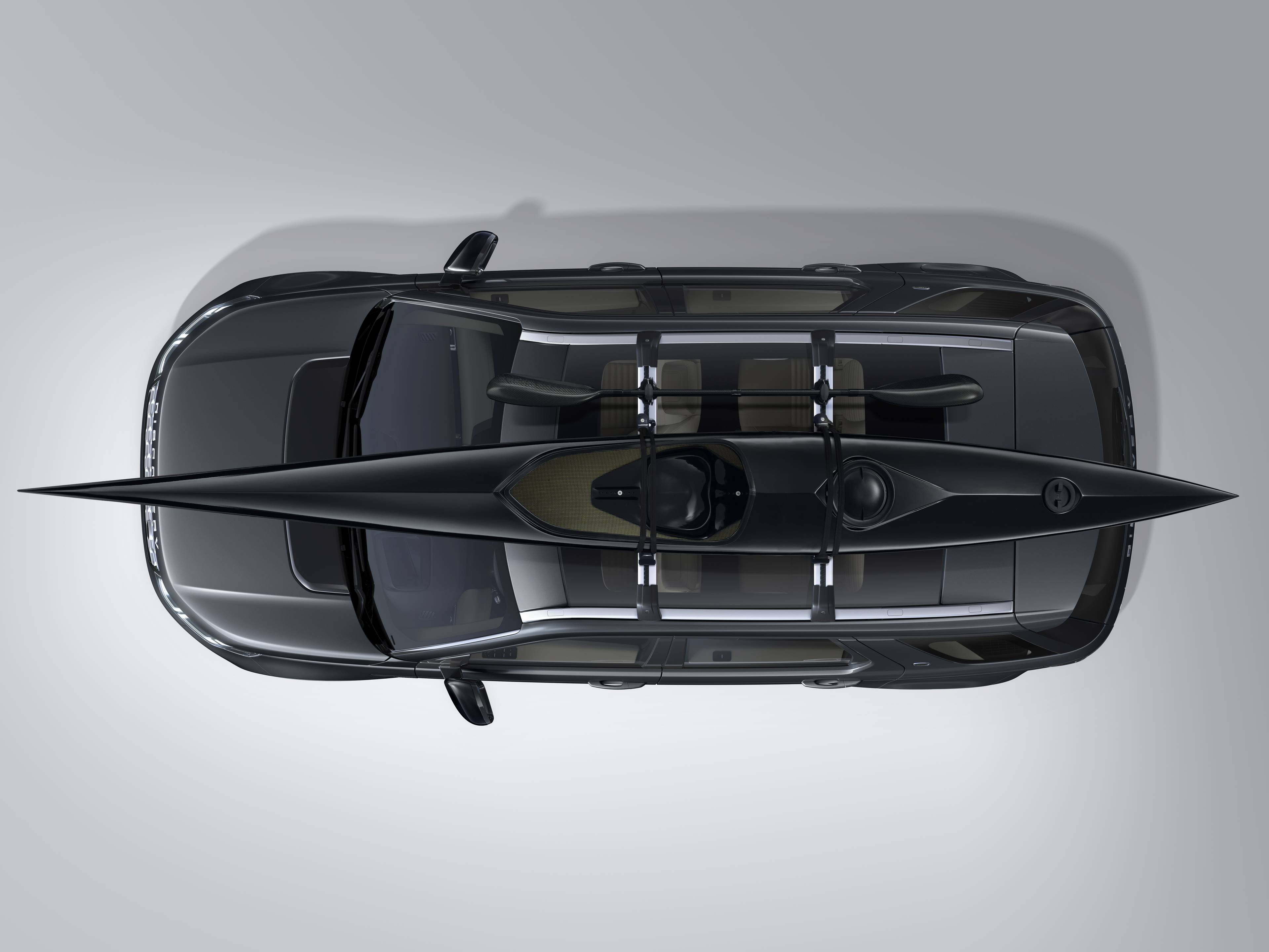 birds eye view of black discovery with a kayak attached to the roof