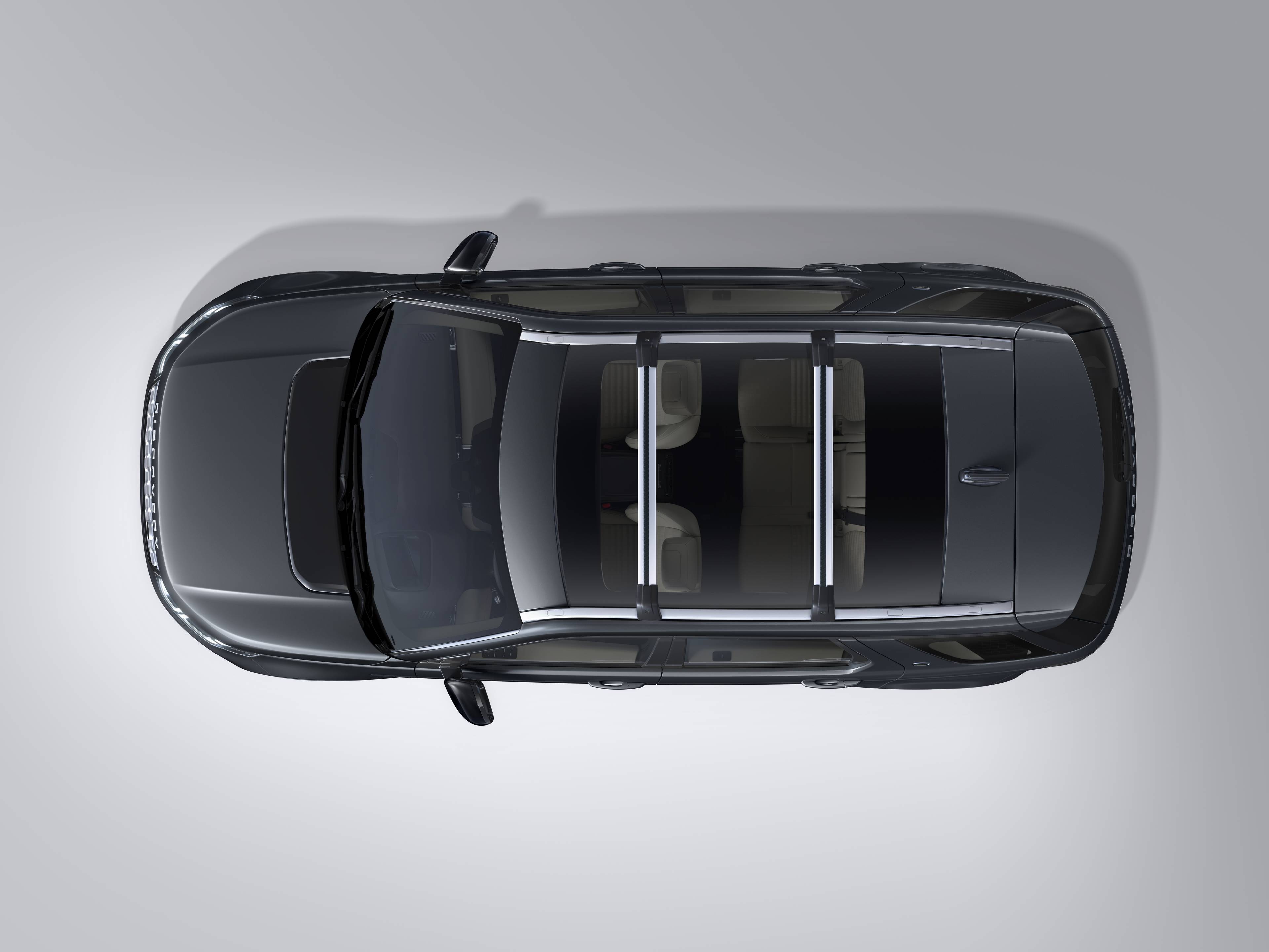 birds eye view of black discovery sport with cross bars on the roof