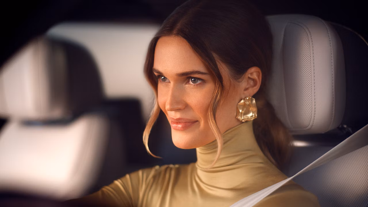 Lady facing front, driving a Range Rover with Seatbelt on Lady facing front