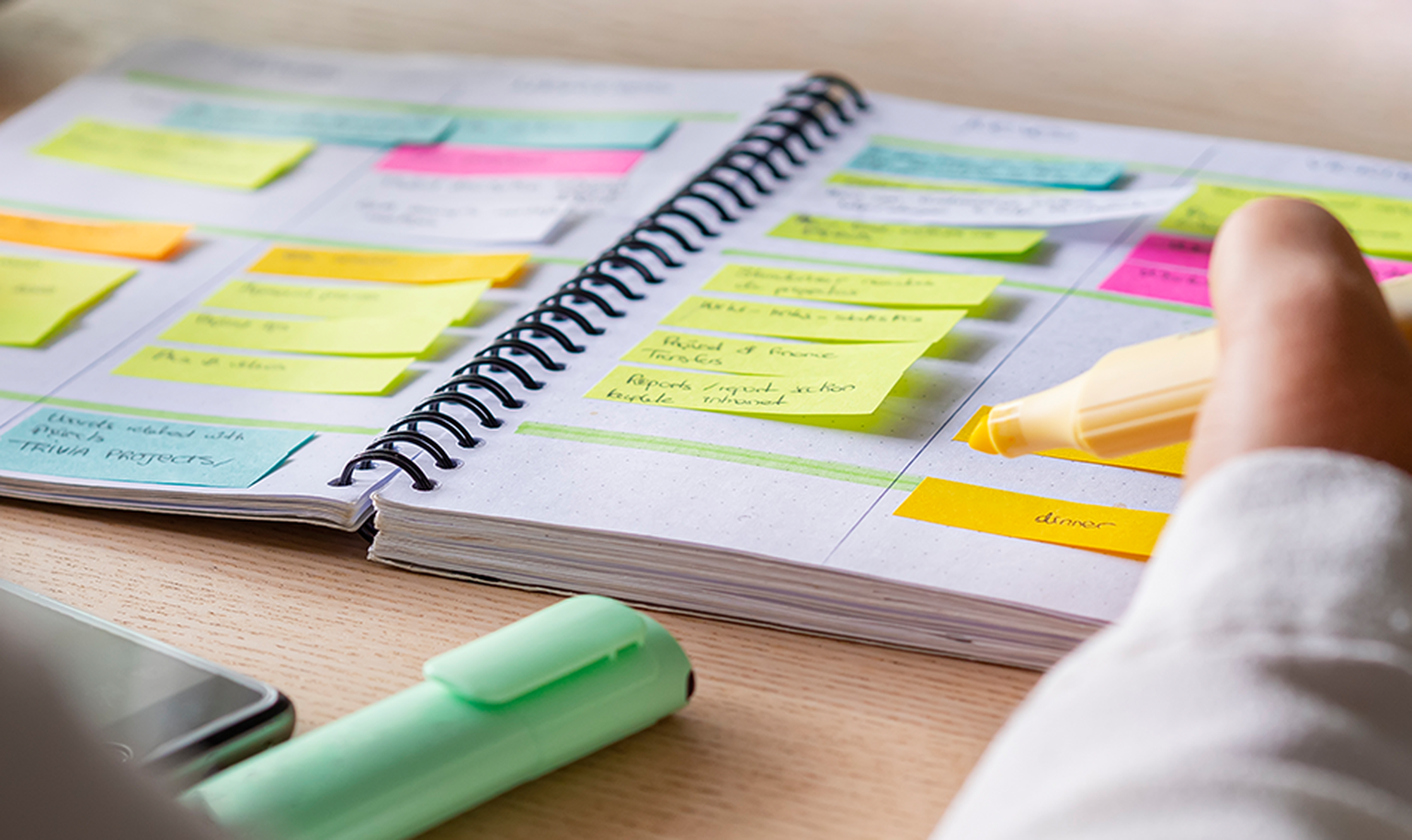 notebook with person highlighting and sticky notes