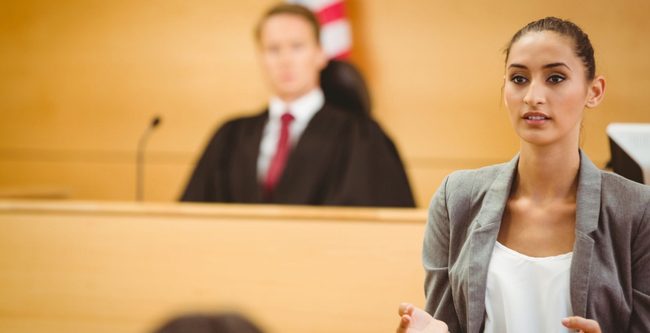 lawyer in a court room with judge in background