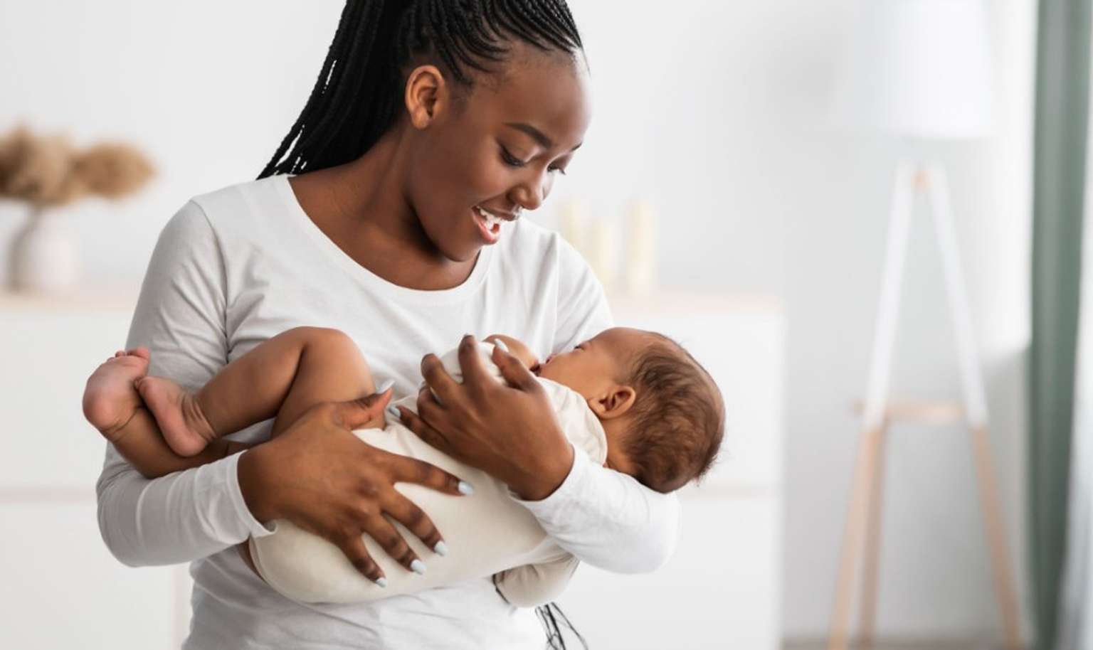 young mother holding her baby in her arms