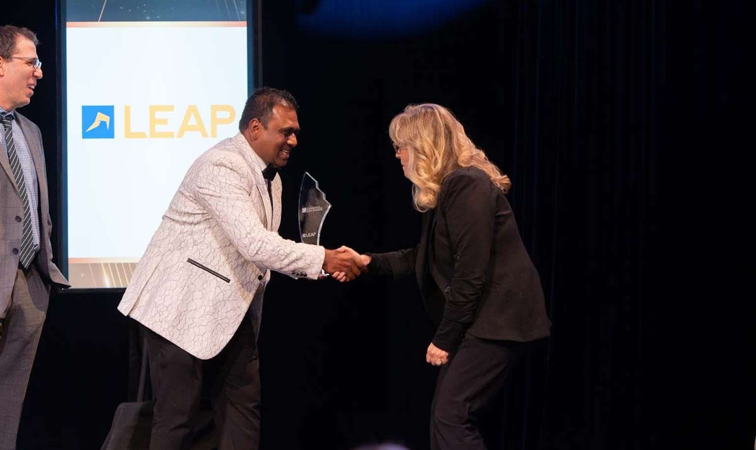person handing award to another person