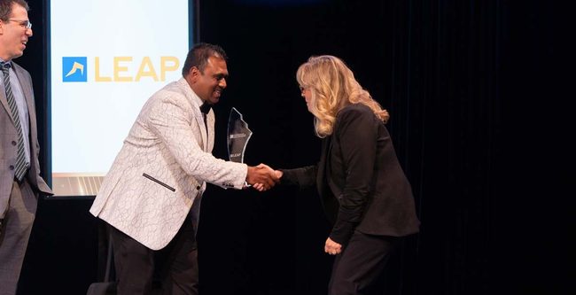 person handing award to another person