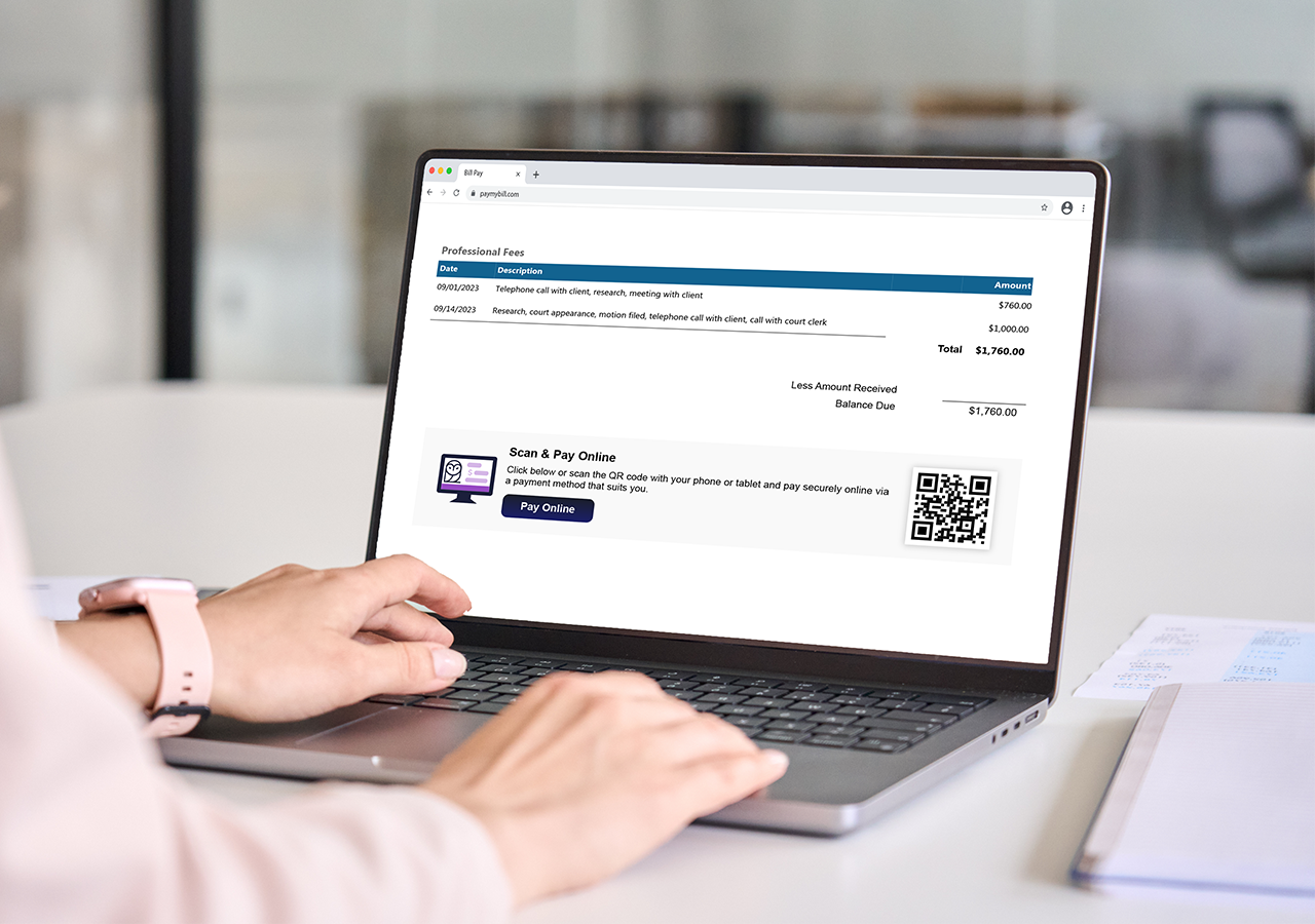 Person using a laptop displaying an online invoice for professional fees with a "Scan & Pay Online" option and QR code.