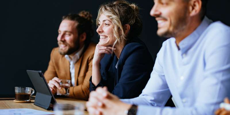 three people at work smiling