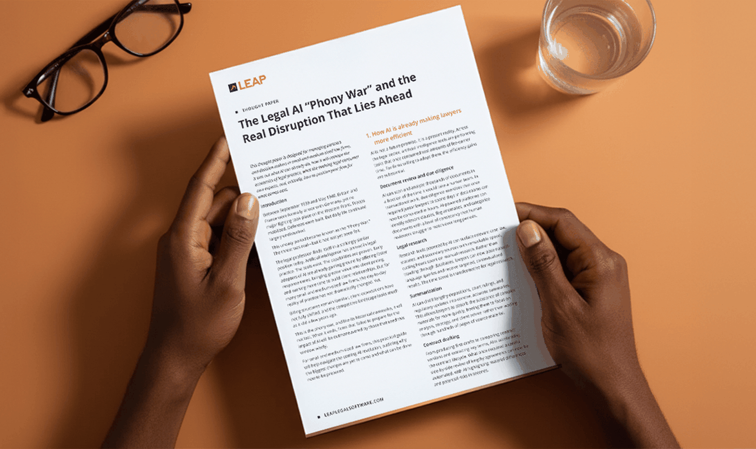 Hands holding a document titled "The Legal AI 'Phony War'" on a desk with a pair of glasses and a glass of water.