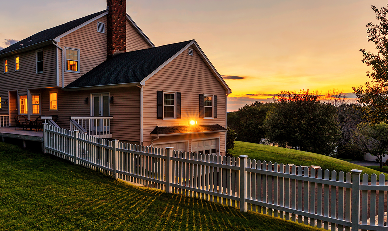A countryside house with sunset in the background