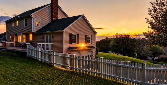 A countryside house with sunset in the background