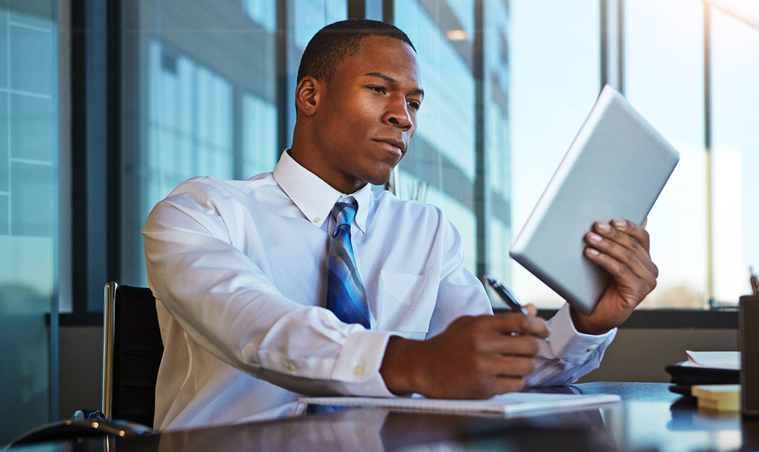 lawyer looking at tablet and taking notes