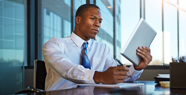 lawyer looking at tablet and taking notes