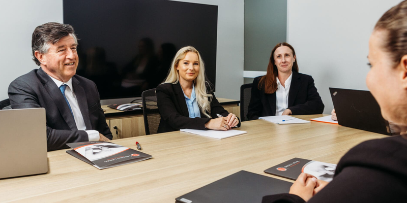 Soden legal team at a table with laptops