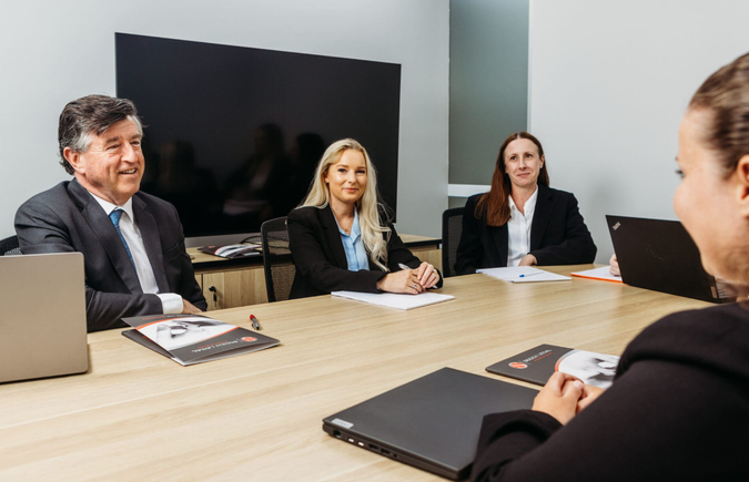 Soden legal team at a table with laptops