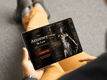 Person holding a tablet displaying a legal website with an image of Lady Justice and options for contacting an attorney.