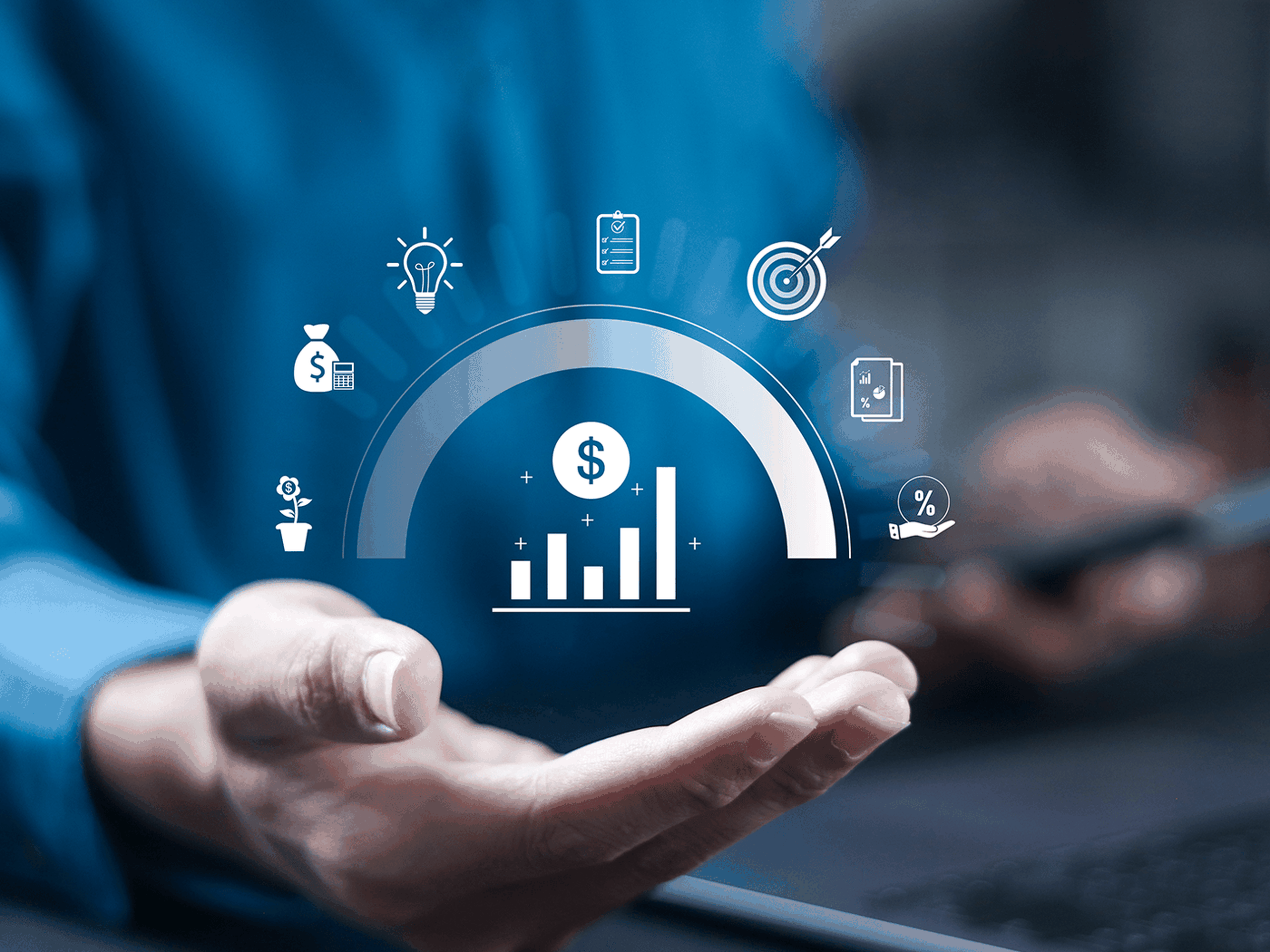Hand holding holographic financial icons, including bar graph, dollar sign, and light bulb, symbolizing business growth and strategy.