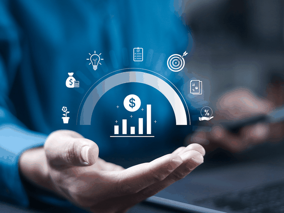 Hand holding holographic financial icons, including bar graph, dollar sign, and light bulb, symbolizing business growth and strategy.