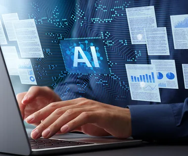 Hands typing on a laptop with floating digital documents and an AI symbol on a circuit background, symbolizing artificial intelligence technology.