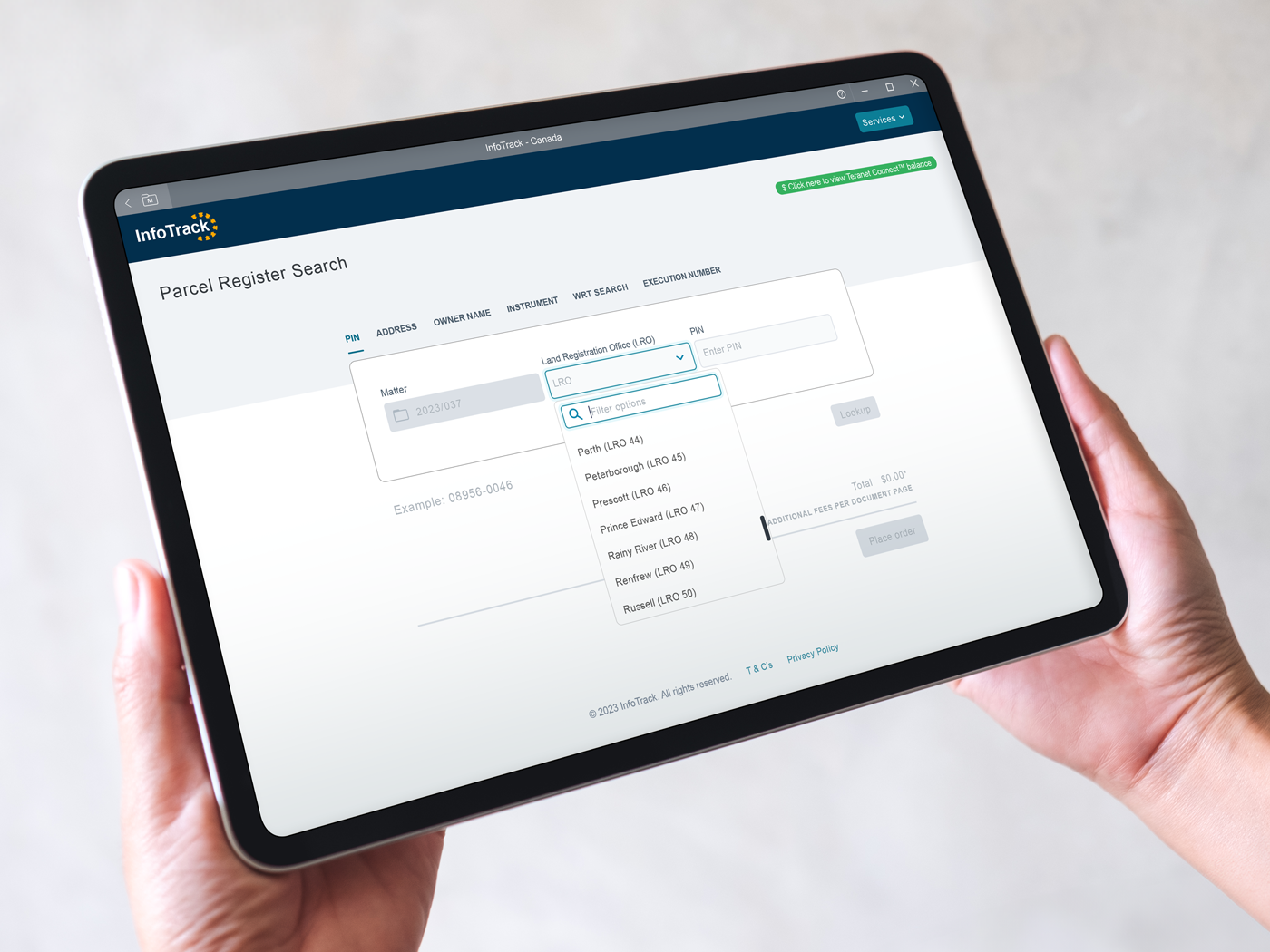 hands holding a tablet with infotrack in leap open