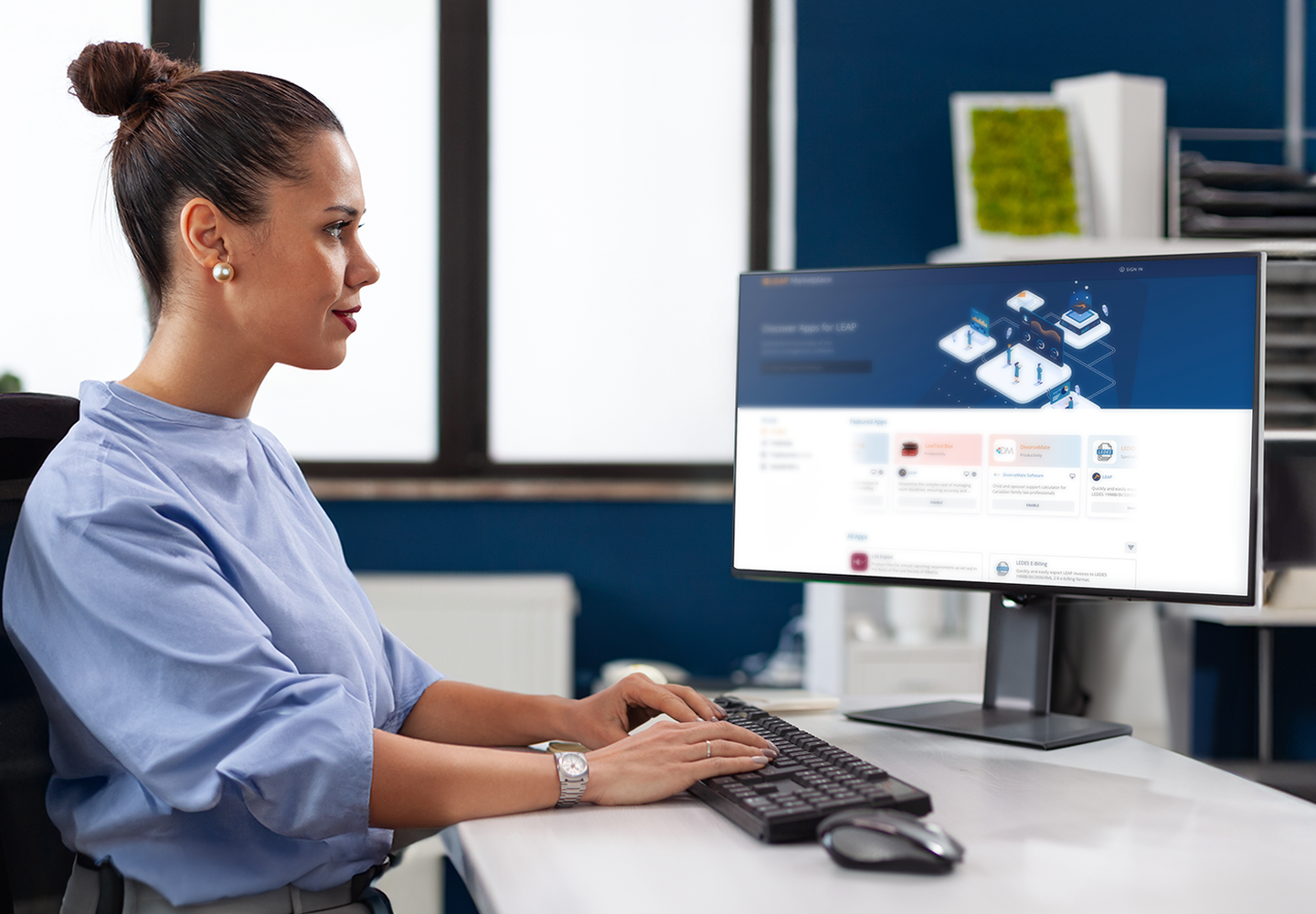 a person sitting at a desk using a computer