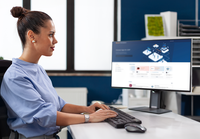 a person sitting at a desk using a computer