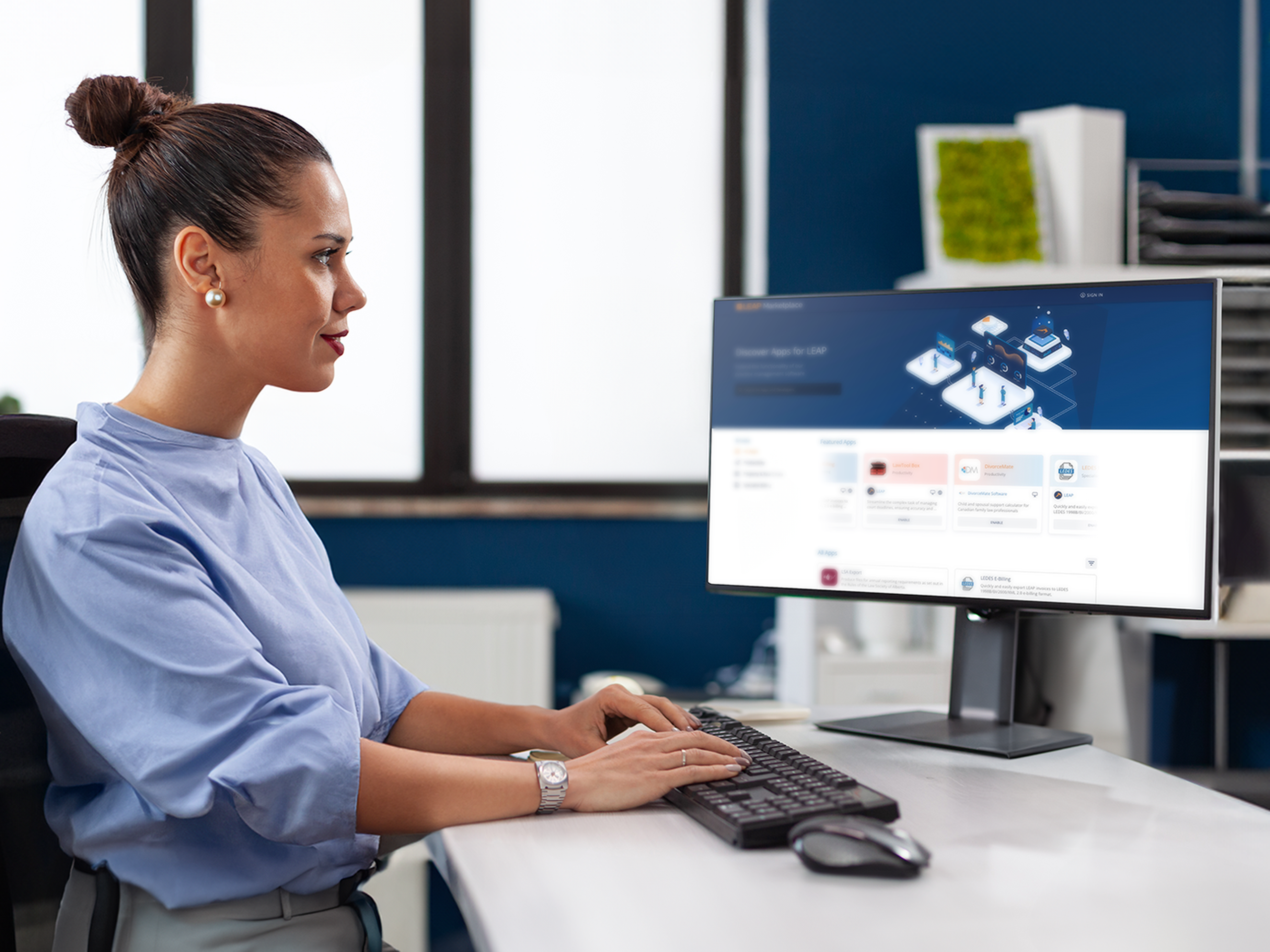a person sitting at a desk using a computer