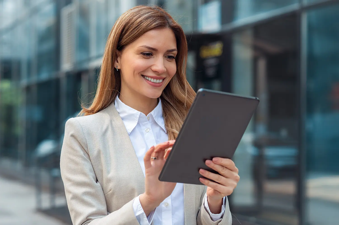 Women smiling and looking at iPad