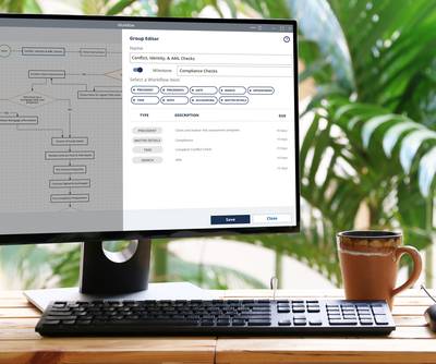 Computer screen displaying a workflow editor with a flowchart and task list, next to a potted plant and a mug on a wooden desk.