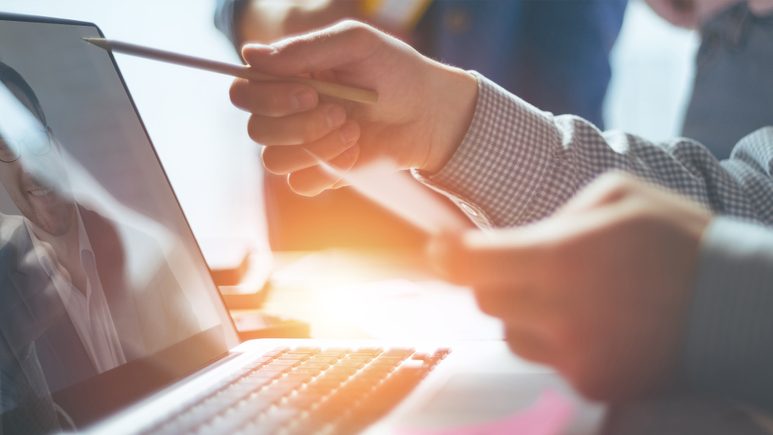 lawyer looking at laptop screen and pointing out key features