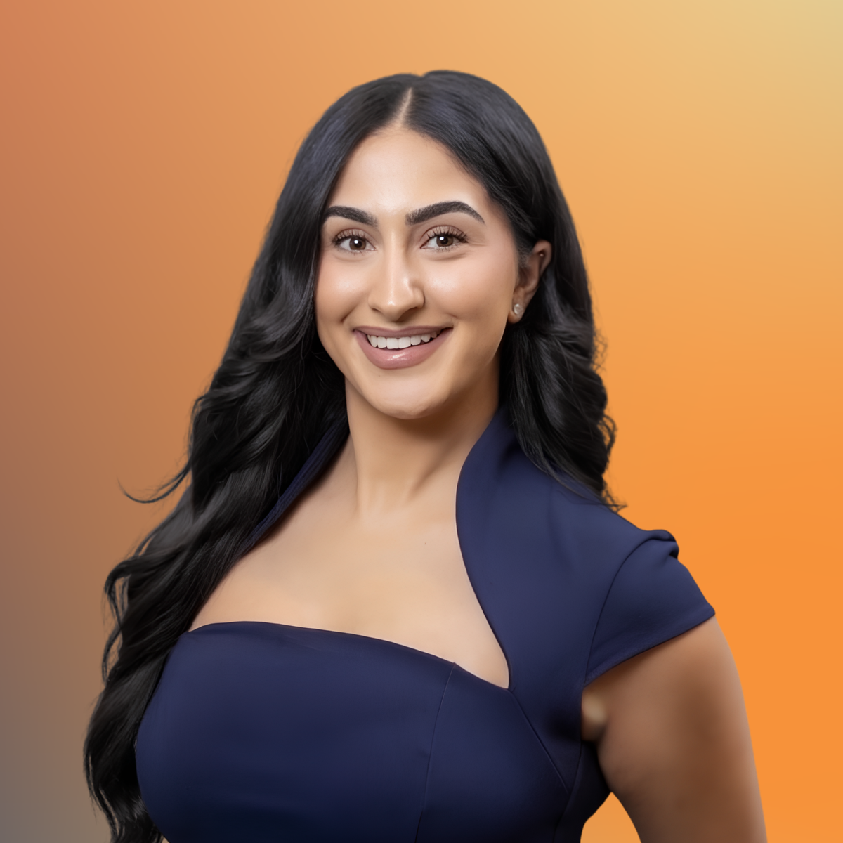 Smiling woman with long dark hair in a navy blue dress against a gradient orange background.