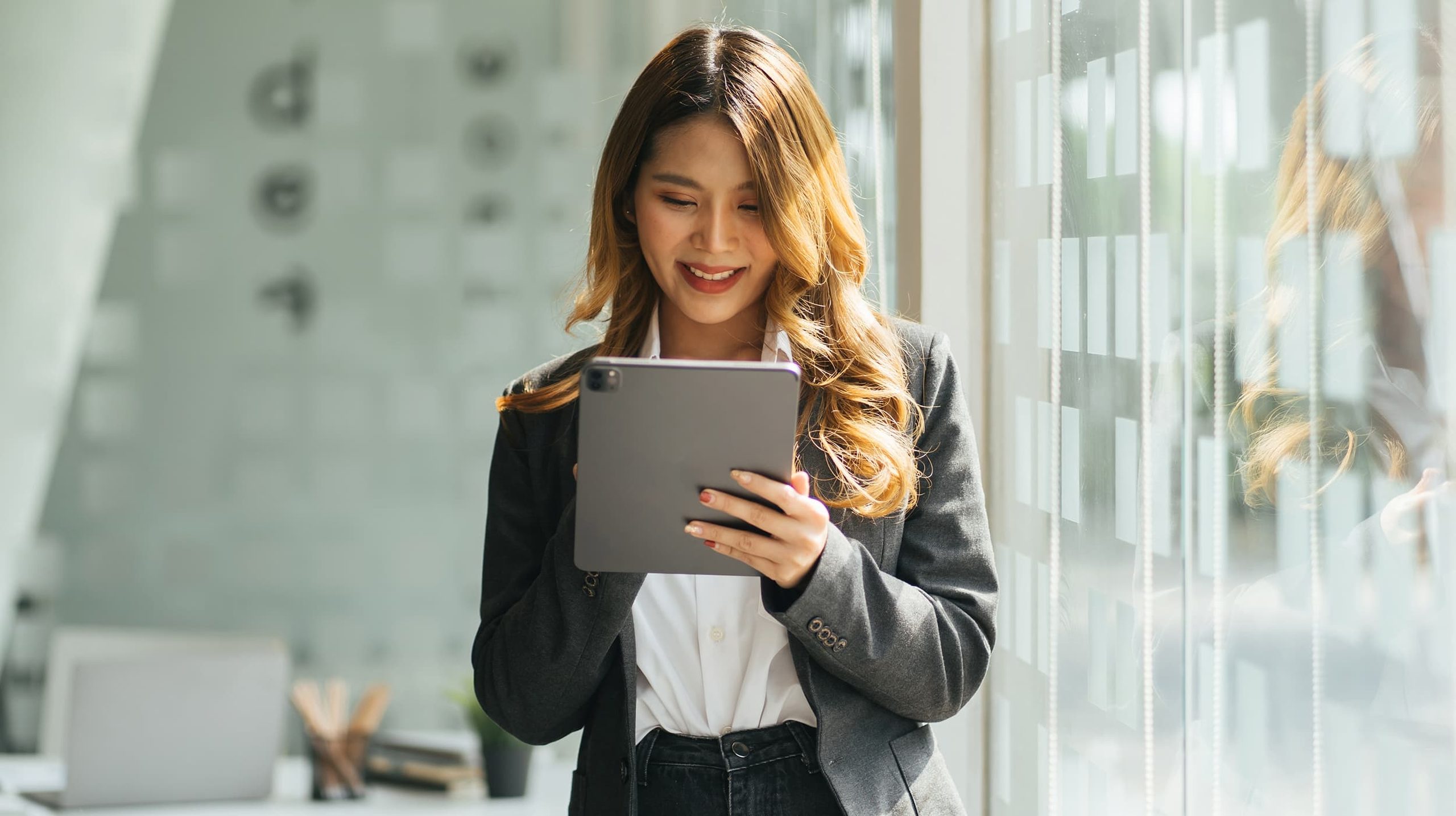 Women looking at iPad while smiling