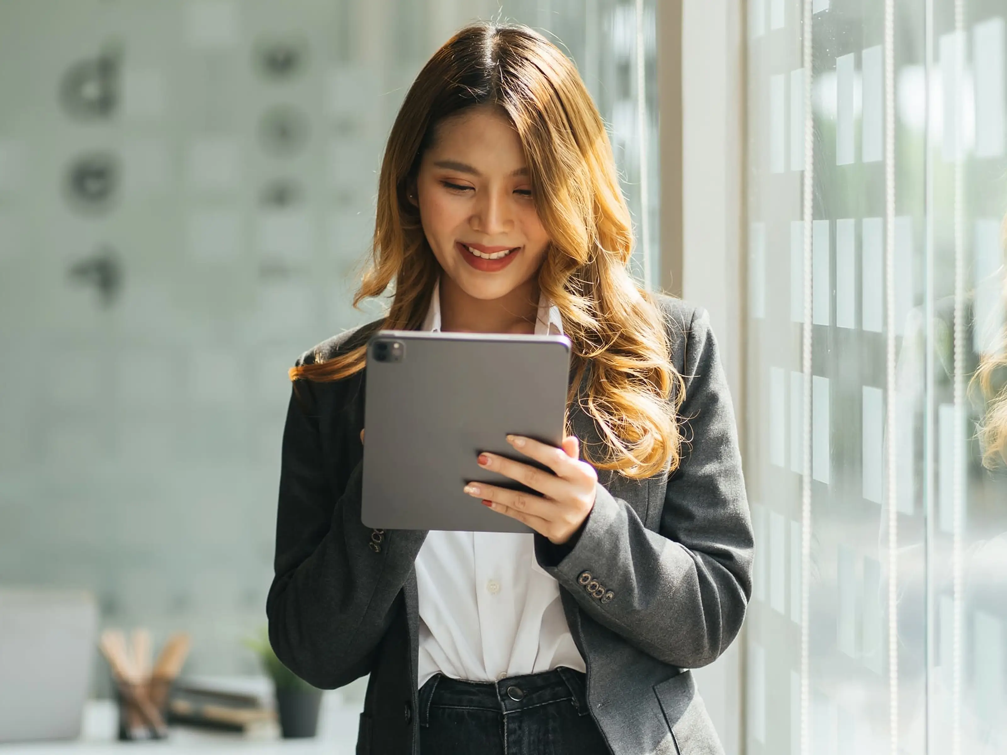 Women looking at iPad while smiling
