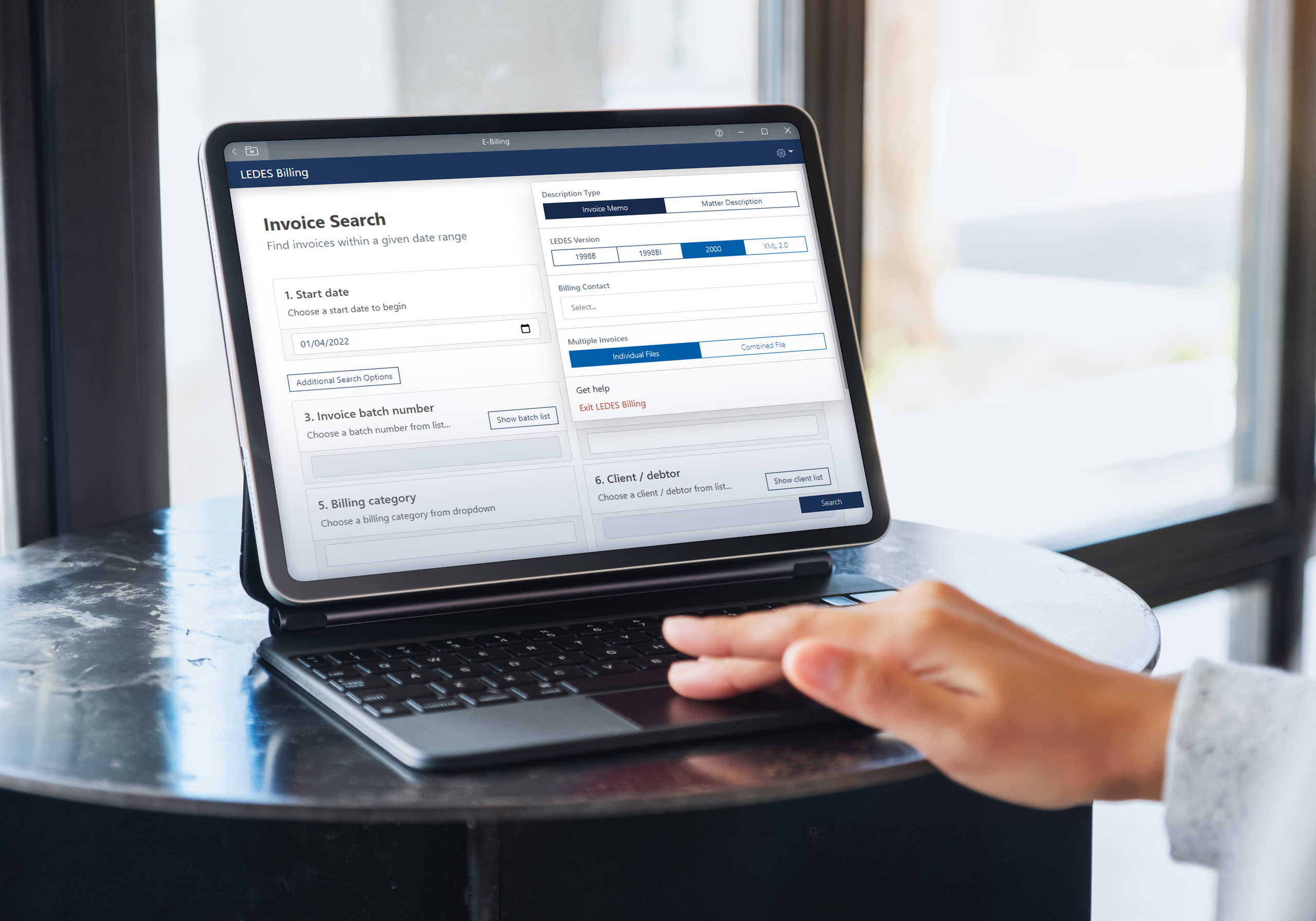 person typing on tablet on a table