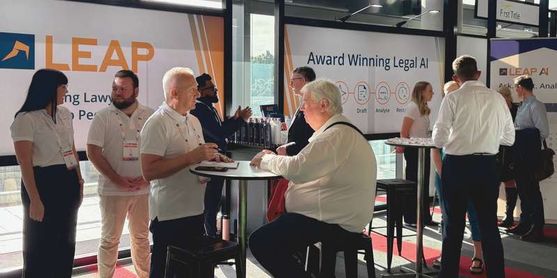 LEAP Legal Software conference booth with lawyers chatting to LEAP representatives.