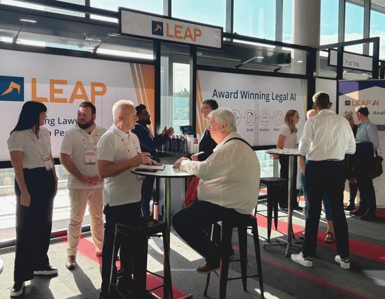LEAP Legal Software conference booth with lawyers chatting to LEAP representatives.