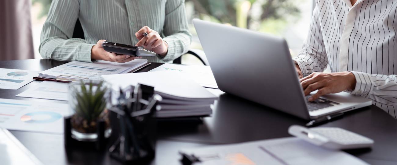 people working with papers and calculators