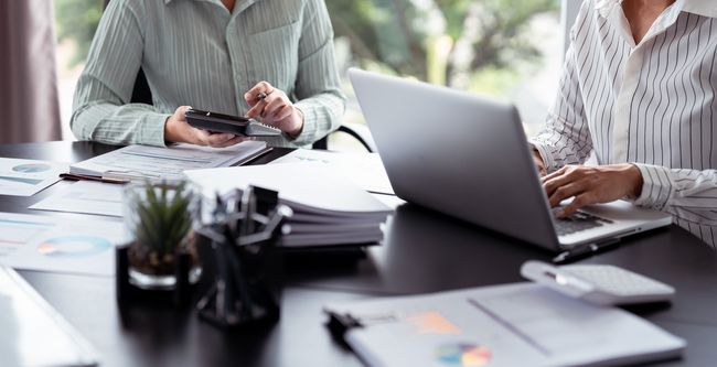 people working with papers and calculators