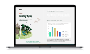Laptop displaying a report titled "The Integrity Gap" with a graph and illustration of trees on the screen.