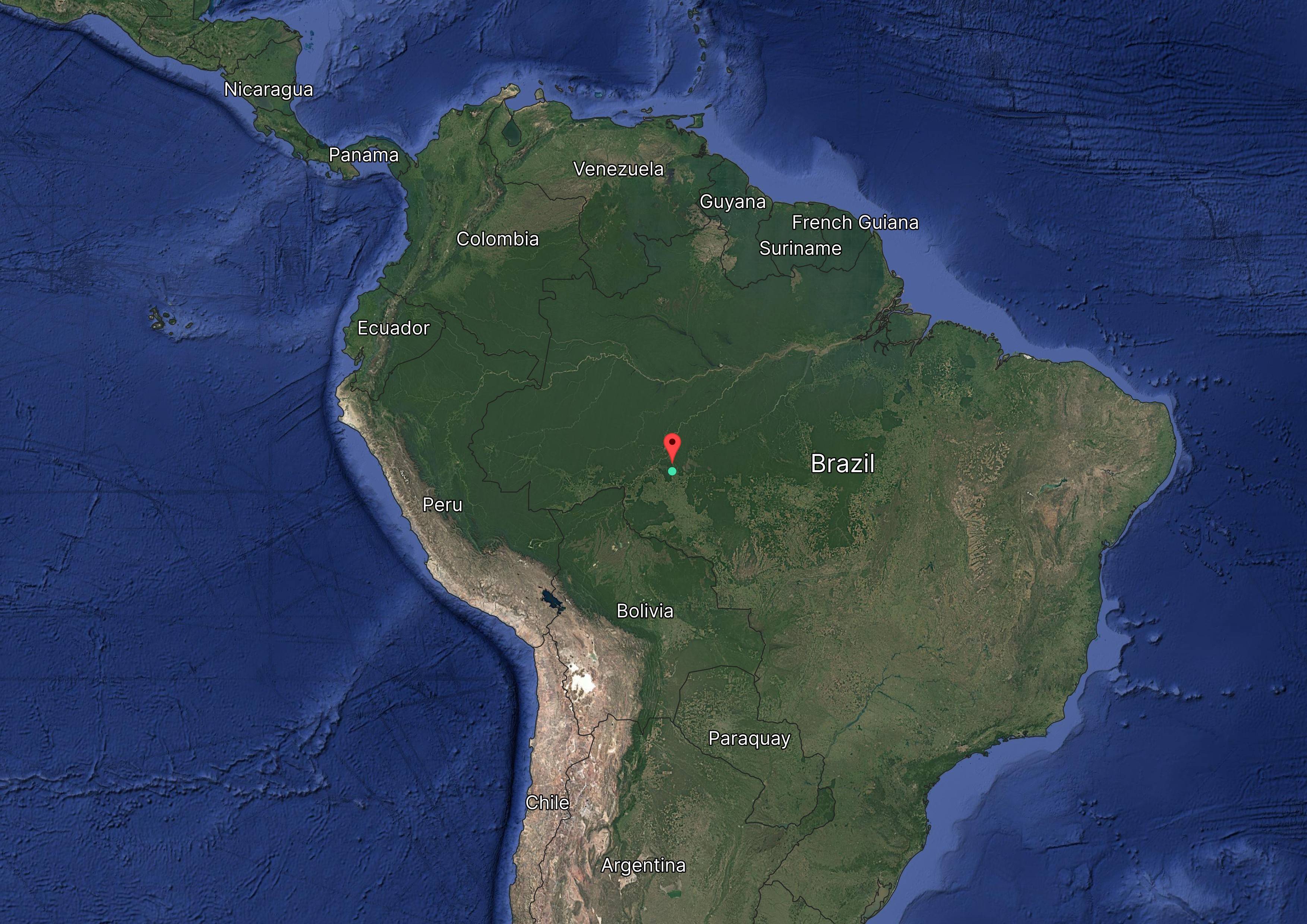 Satellite map of northern South America highlighting countries like Brazil, Colombia, and Peru, with a red pin in the Amazon region of Brazil.