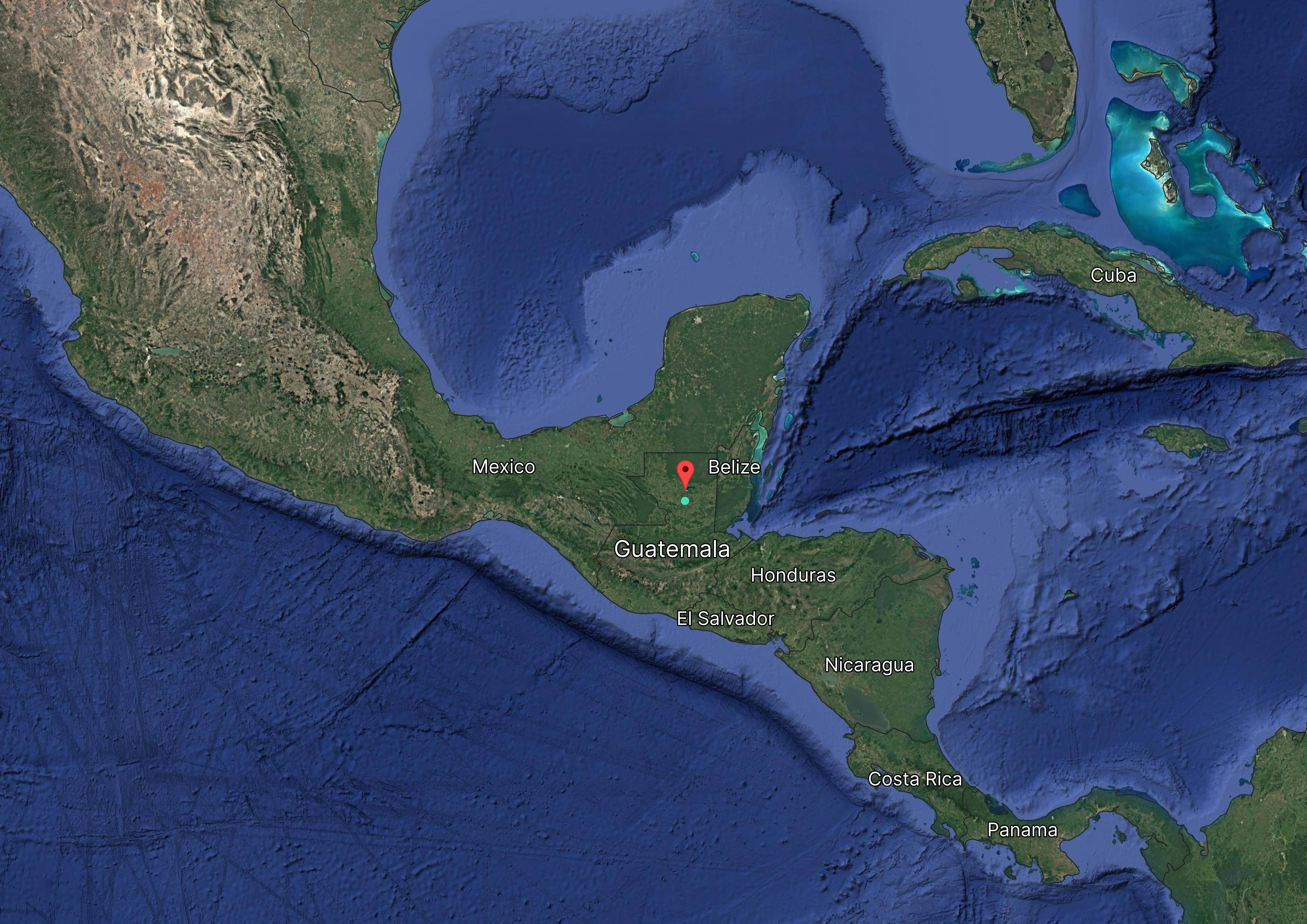 Satellite view of Central America highlighting Belize with a red marker, surrounded by Mexico, Guatemala, Honduras, Nicaragua, and El Salvador.