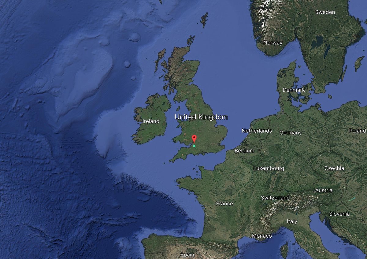 Satellite map view of the United Kingdom and surrounding countries in Europe, with a red marker on a location in southern England.