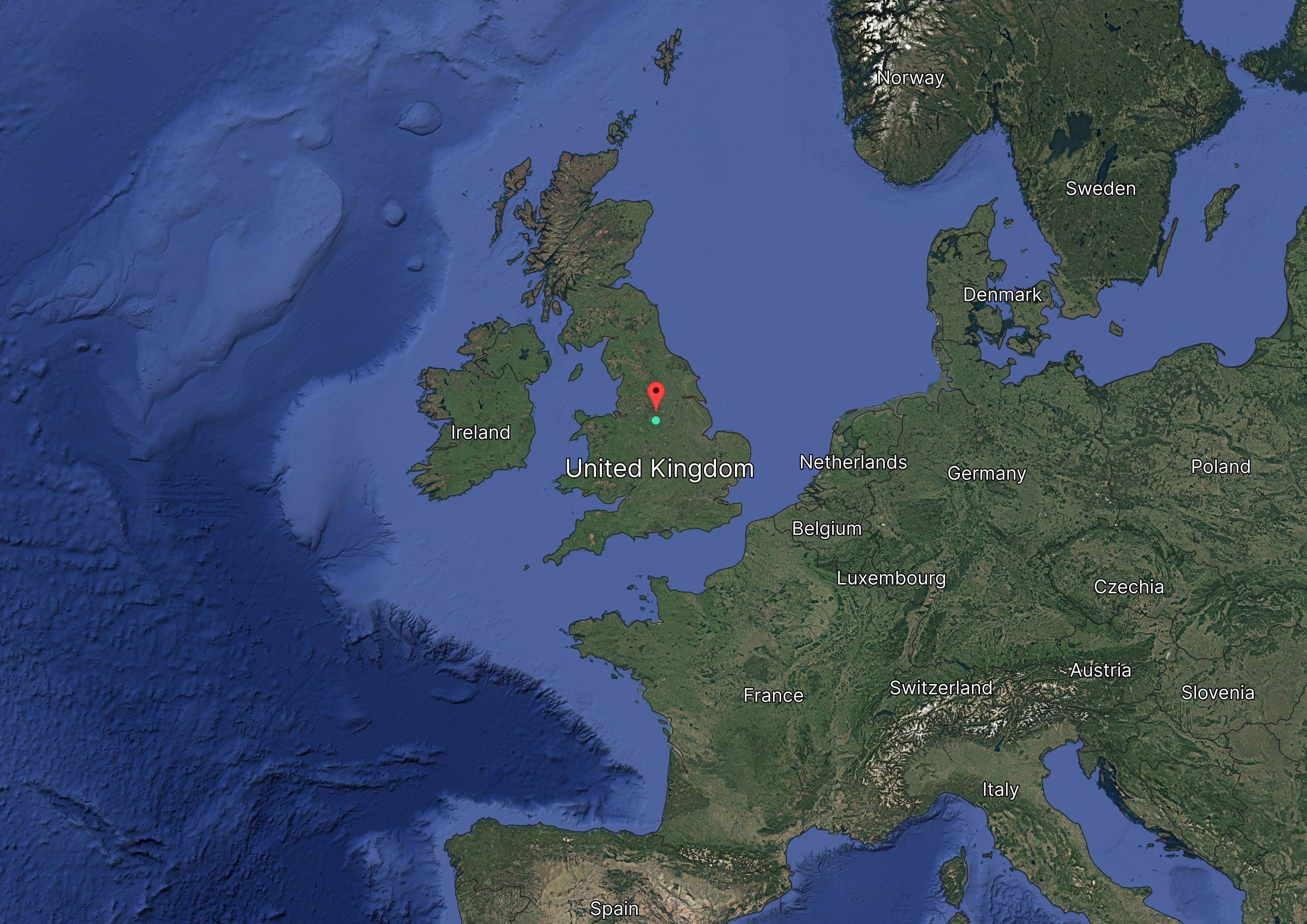 Satellite map of Europe with a pin marking a location in the United Kingdom. Neighboring countries visible: Ireland, France, Germany, and more.