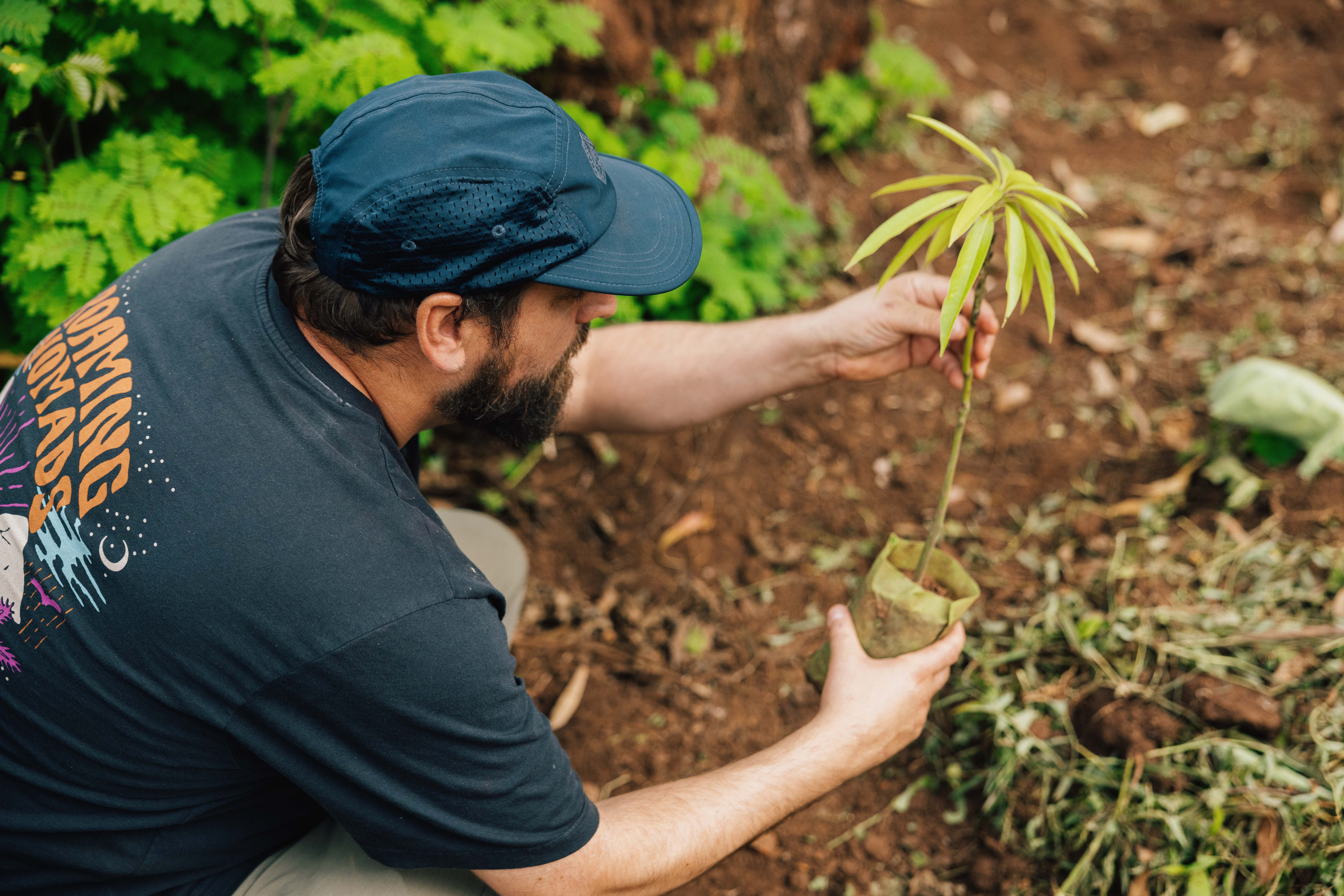 Passenger founder Richard Sutcliffe with a grafted plant during a visit to one of Passenger's restoration projects in Uganda.