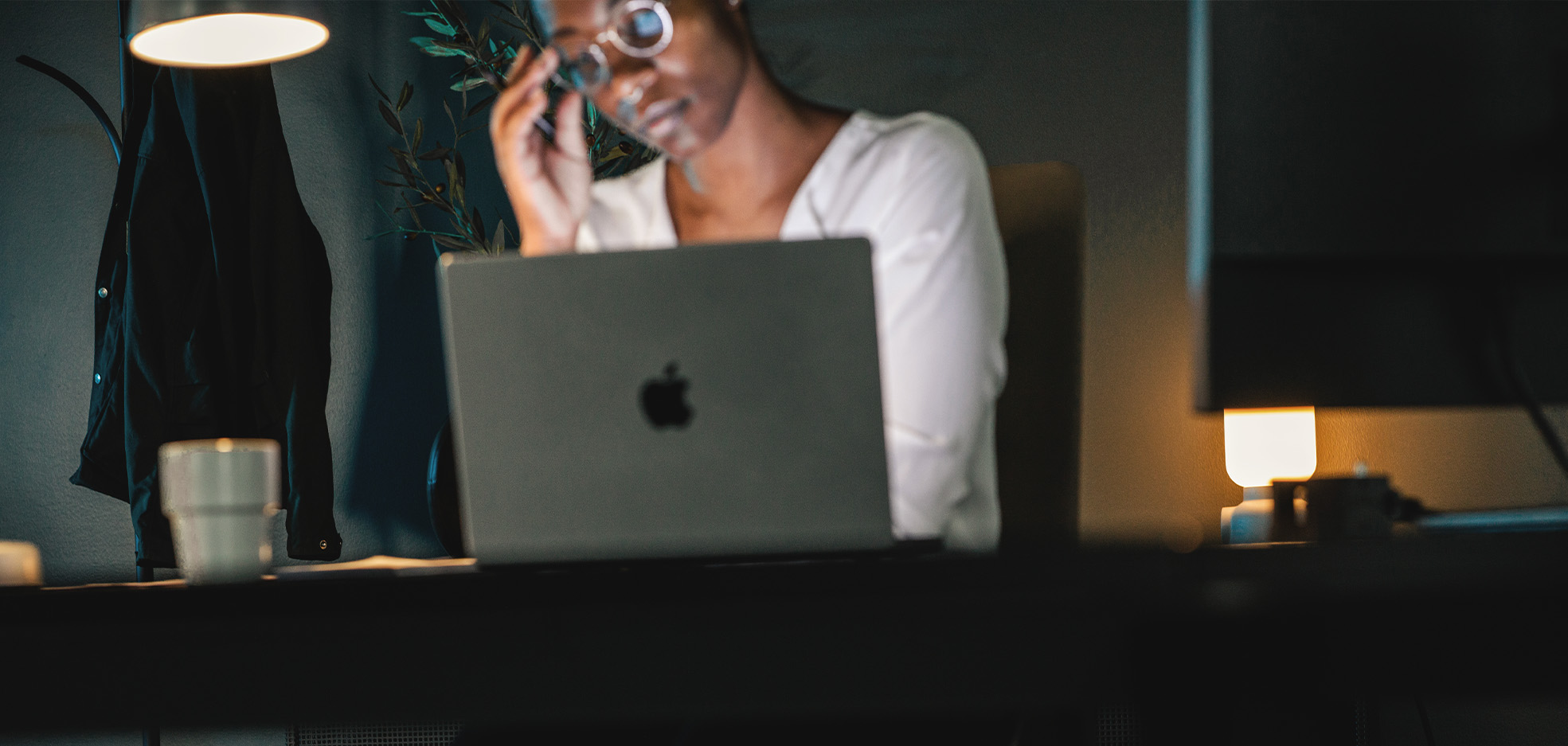 Kvinna sitter framför dator och tänker