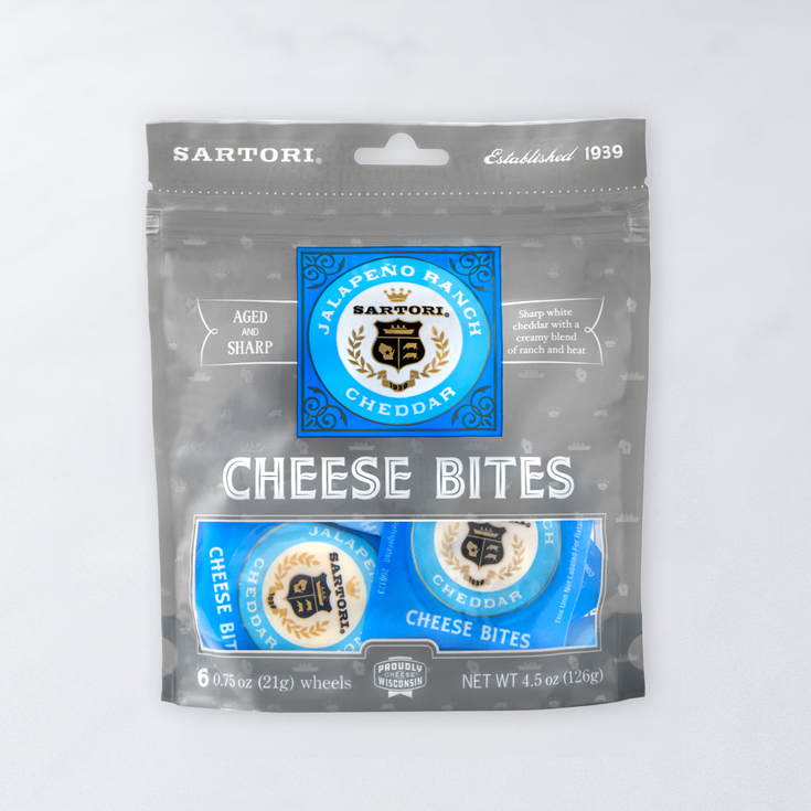 Package of Sartori Cheese Bites, Jalapeño Ranch Cheddar flavor, six 0.75 oz wheels, labeled "Aged and Sharp," made in Wisconsin.
