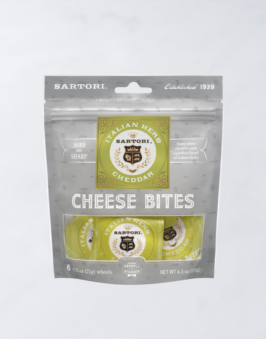 Sartori Italian Herb Cheddar Cheese Bites packaging, containing six aged and sharp cheese wheels, proudly crafted in Wisconsin.