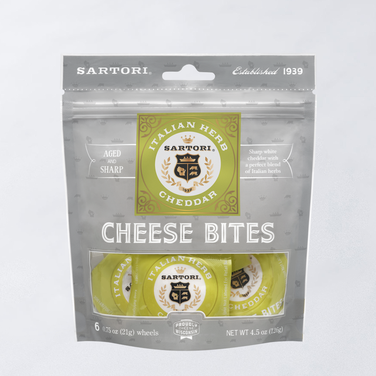 Sartori Italian Herb Cheddar Cheese Bites packaging, containing six aged and sharp cheese wheels, proudly crafted in Wisconsin.